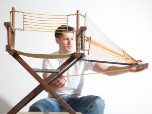 Designer repairs a chair with innovative structural components
