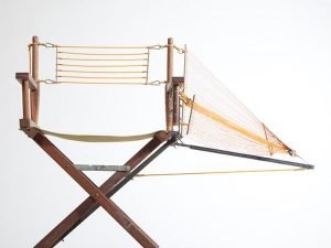 Designer repairs a chair with innovative structural components