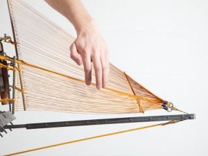 Designer repairs a chair with innovative structural components