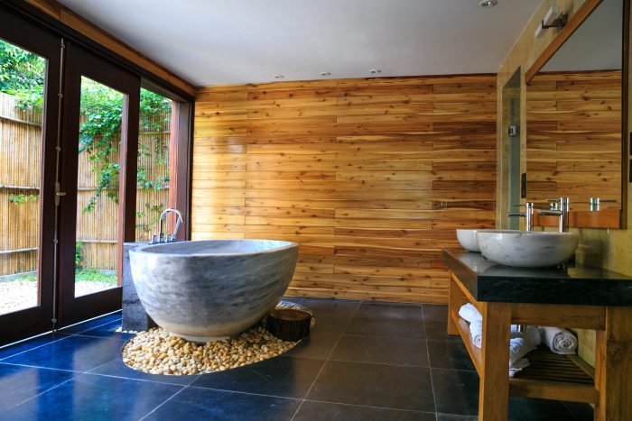 bathroom bathtub with wooden wall