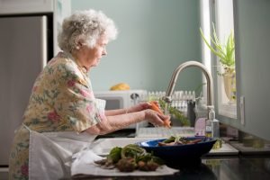 older woman washing dishes