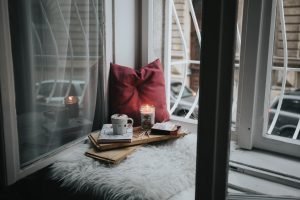 pillow and candle near window