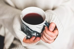 warm tea cup held in both hands