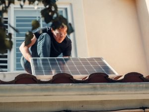man installing solar panel